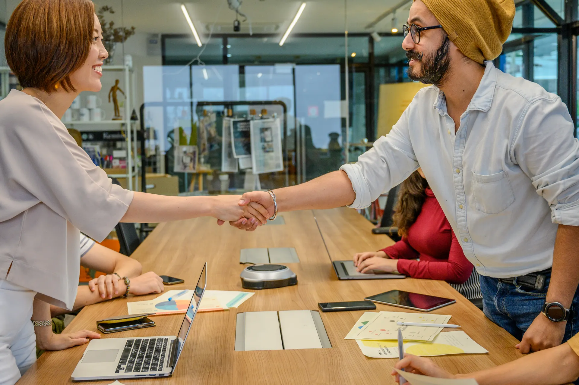 Business professionals exchanging a handshake during a meeting